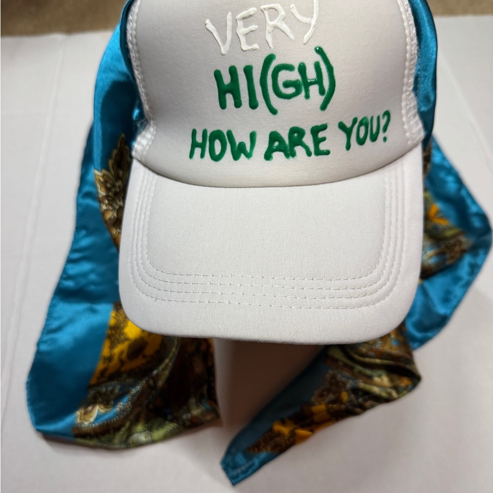 White and Blue Cap with Green Text and scarf attached